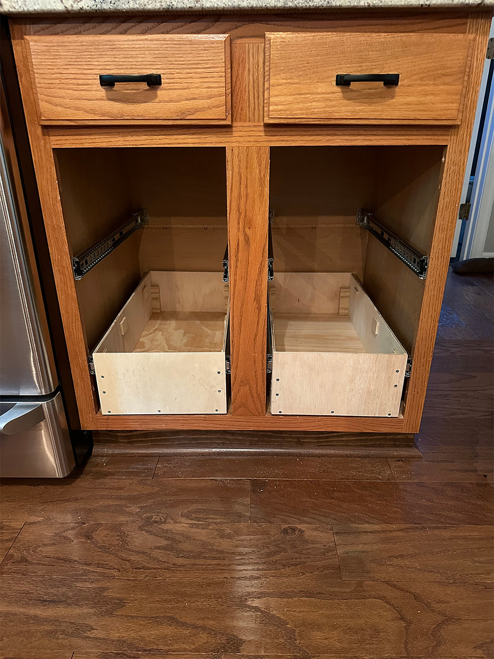 During- Kitchen cabinets with doors off, interior shelf removed and bottom drawers sitting in place
